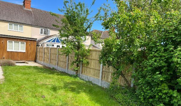 Close-board fence panels with concrete posts and gravel boards